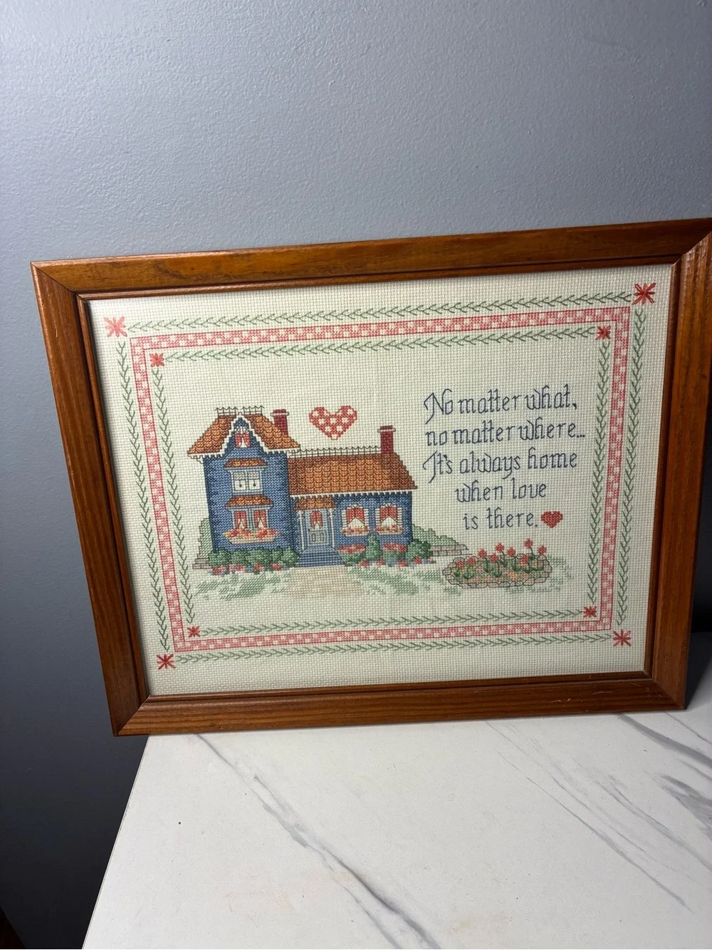 Framed Cross Stitch Home Sampler with Blue House and Quote